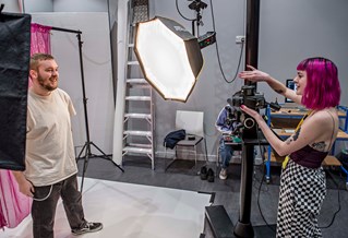 Setting up a model to be photographed in a studio