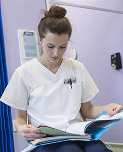 Podiatry student checking patient notes