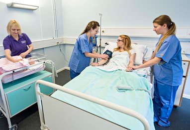 Midwifery staff monitoring a patient
