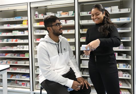 A pharmacist discussing a prescription with a patient