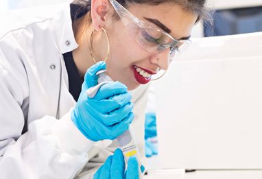 Smiling student working in biomedical lab
