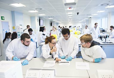 Lecturer explaining things to students in the lab