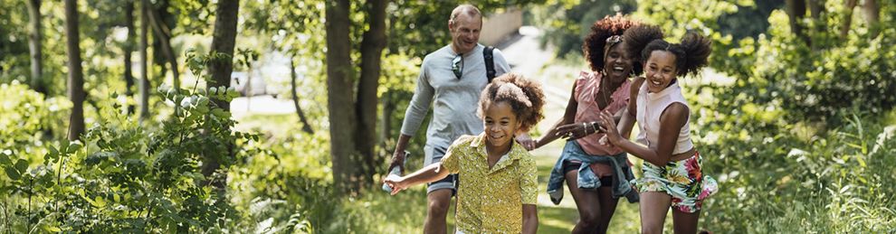 family walking in the woods