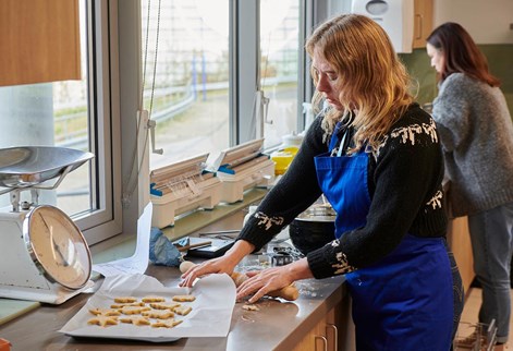 Student placing biscuits on a tray ready for cooking
