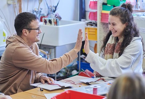 Two students doing a high five