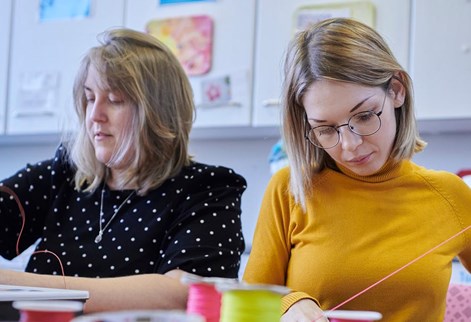 two students doing craft