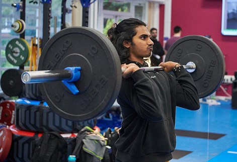 student lifting weights