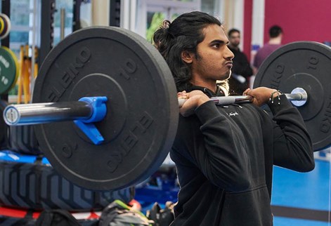 student lifting weights