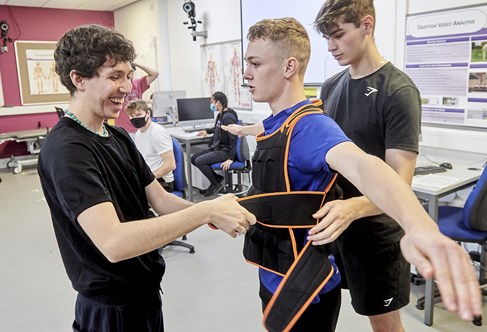 Student being fitted with a weighted vest