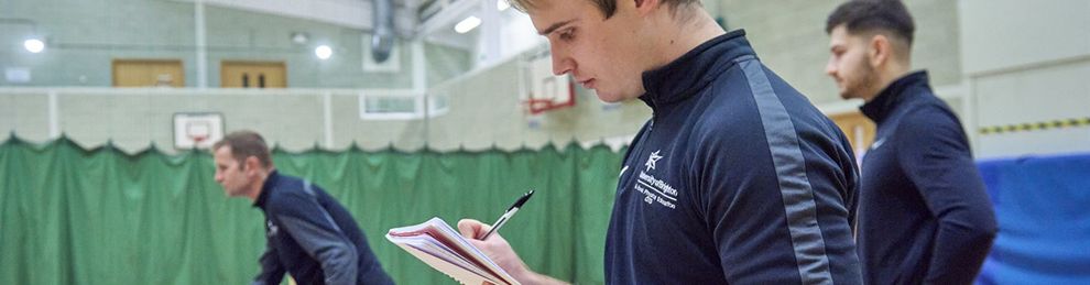 Sport student writing on a clipboard