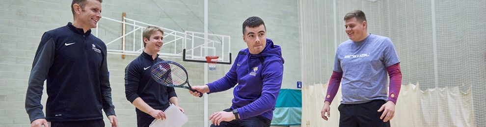 students on a balance board in the gym