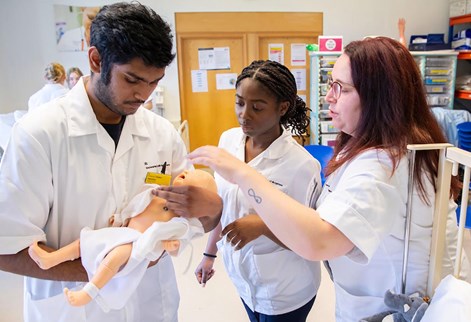 students with a baby mannequin