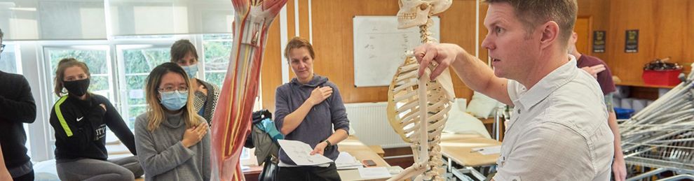 Lecturer using a skeleton to explain movement