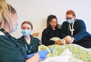 Paramedic and midwifery students learning together in our community flat