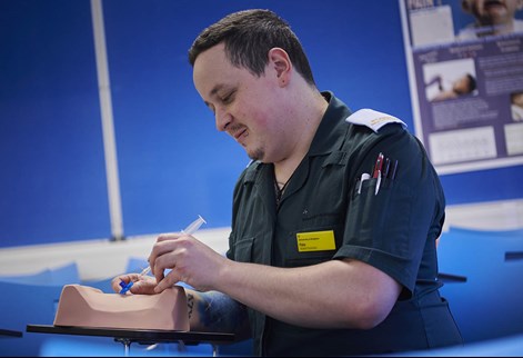 student paramedic practising injection