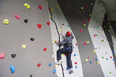 student on a climbing wall