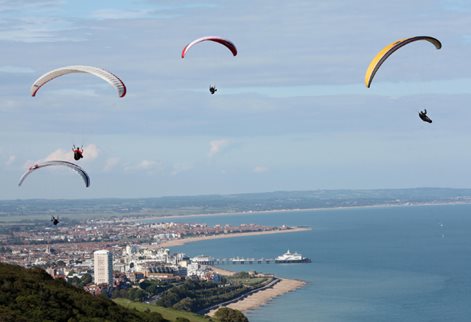 Paragliders with view of Eastbourne