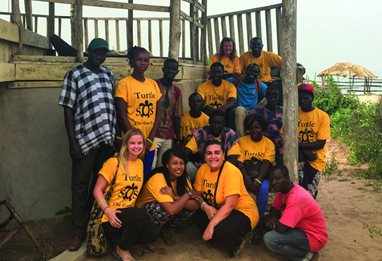 A group of people in Turtle SOS t-shirts in GAMBIA