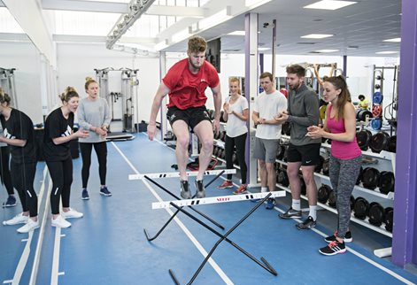 jumping hurdles during fitness testing