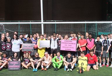 group of students in front of a goal holding banners