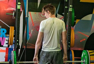 Student lifting weights in the gym