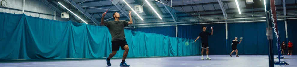 Students playing indoor tennis