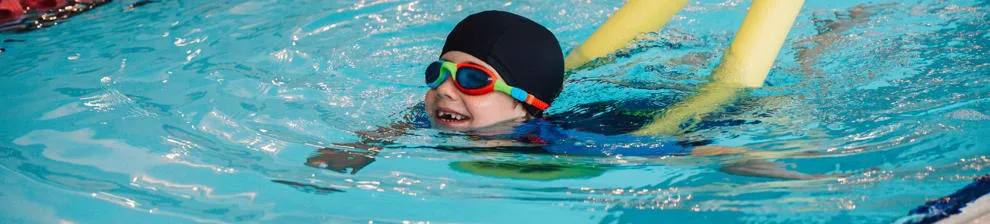 Child being taught how to swim