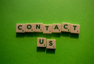 Letters from a Scrabble board spelling out the words: Contact us