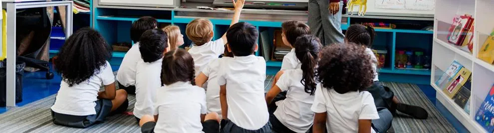 Female teacher leading a whole-class lesson with primary pupils