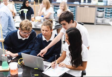 Secondary students working on a science activity in a classroom laboratory.