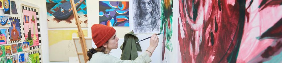 Fine art student painting on a canvas