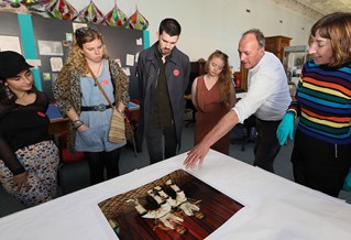 Students discussing a photo on a table