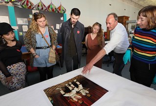 Students discussing a photo on a table