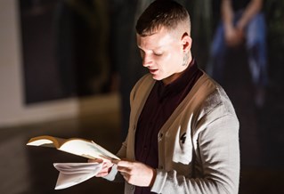 Student reading from a book