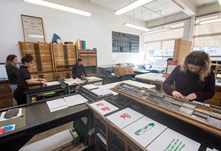 Students using a printmaking workshop