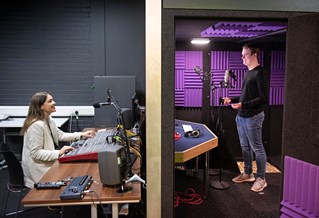 Two students in a recording studio