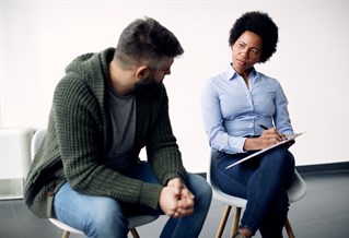 A social worker chatting to a client