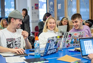 Three students with laptops