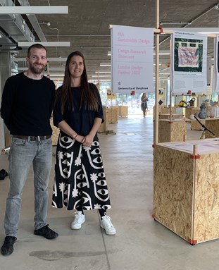 Tom and Sally standing next to each other at exhibition of student work