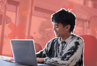 A student using a laptop, on a red background