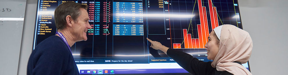 Student and lecturer looking at Bloomberg data