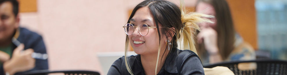 Student smiling in a lecture