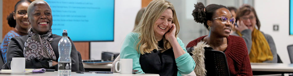 Group of people laughing in a seminar