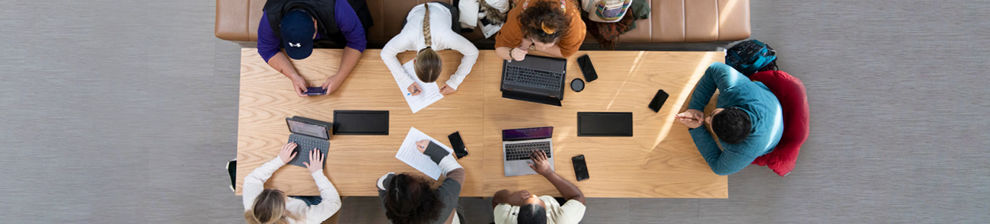 Aerial view of a meeting at a long table