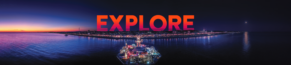 Brighton pier at night with the text 'Explore'