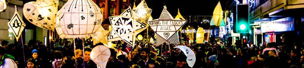 Street full of people carrying brighton lanterns at night