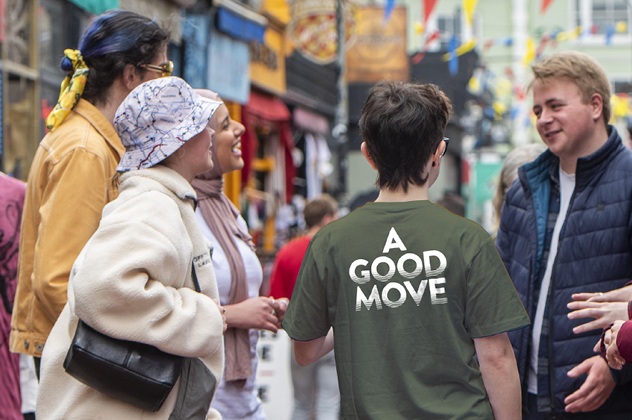 Image of a student rep in a green t-shirt with the words A good move