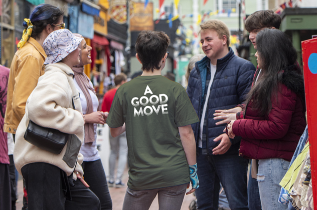 Image of a student rep in a green t-shirt with the words A good move