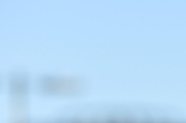 Student in a graduation gown on Brighton seafront, with the text 'Number 1 university in Europe for international students, 2026 - EduOpinions'