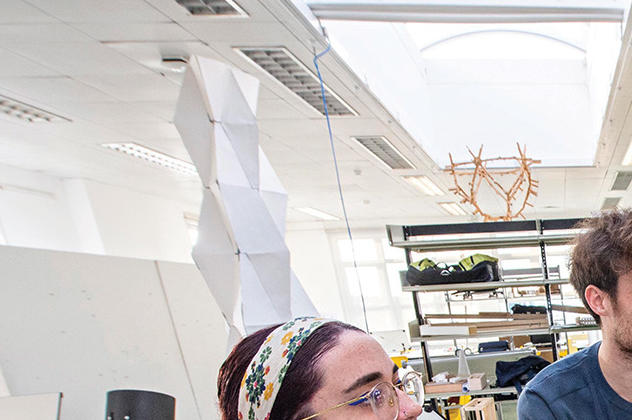 Three students in the architecture drawing studio